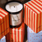 Elegant La Maison Rose candle with striped packaging, capturing the serene scent of Provence.