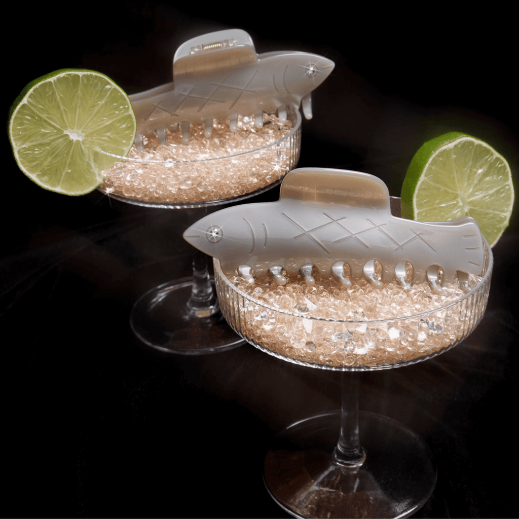 HERRING HAIR CLAW featured on cocktail glasses with lime wedges, blending whimsy and functionality in a coastal theme.