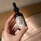 Hand holding a bottle of Wooden Spoon Herbs Head Helper, a calming herbal tincture for relaxation and stress relief.