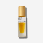Light Beam natural perfume bottle with golden cap, featuring radiant yuzu and rose otto scents.