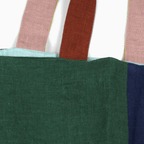 Close-up of the Small Linen Tote Bag - Wanderer featuring colorful handles and two-tone linen fabric.