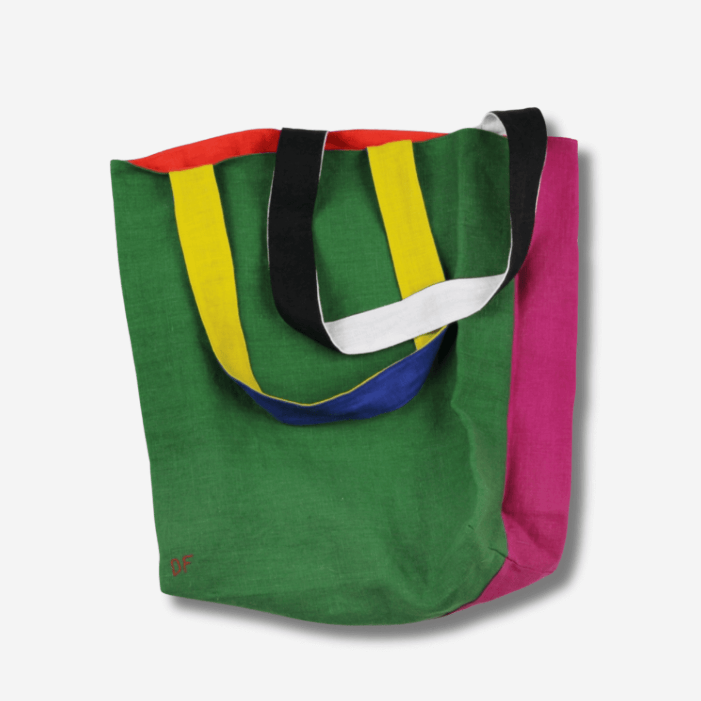Vibrant two-sided linen tote bag in green, pink, and colorful straps, perfect for versatile daily use.