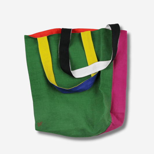 Vibrant two-sided linen tote bag in green, pink, and colorful straps, perfect for versatile daily use.