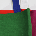 Close-up of colorful linen tote bag in green, showcasing vibrant side panels and sturdy straps.