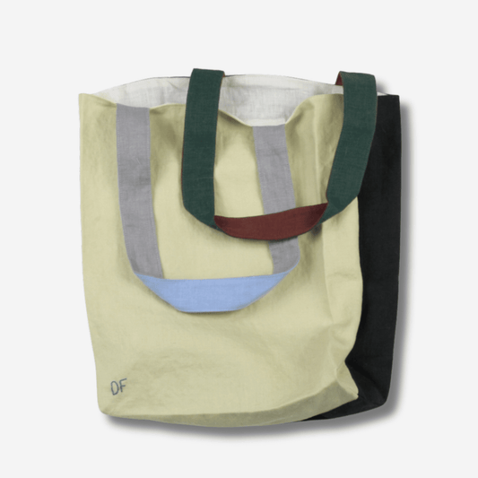 Two-tone linen tote bag by Slowdance featuring green, gray, maroon, and black straps, reversible design for versatile use.