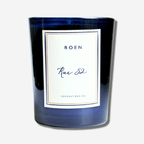 RUE 52 candle in a blue glass vessel, featuring a stylish label and made from coconut wax, 8 oz size.