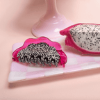 Vibrant pink dragon fruit hair claw clip with speckled detail, perfect for stylish hair days.