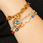 Colorful Malak bracelet with gold-plated aluminum and evil eye charms on a wrist, symbolizing protection and love.