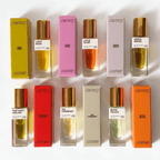 Colorful lineup of natural perfumes including Green Smoke, Lotus Eater, and Fortune's Darling in elegant bottles.