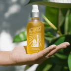 Botanical cleansing oil in a hand, showcasing a luxurious formula for makeup removal and skin hydration.