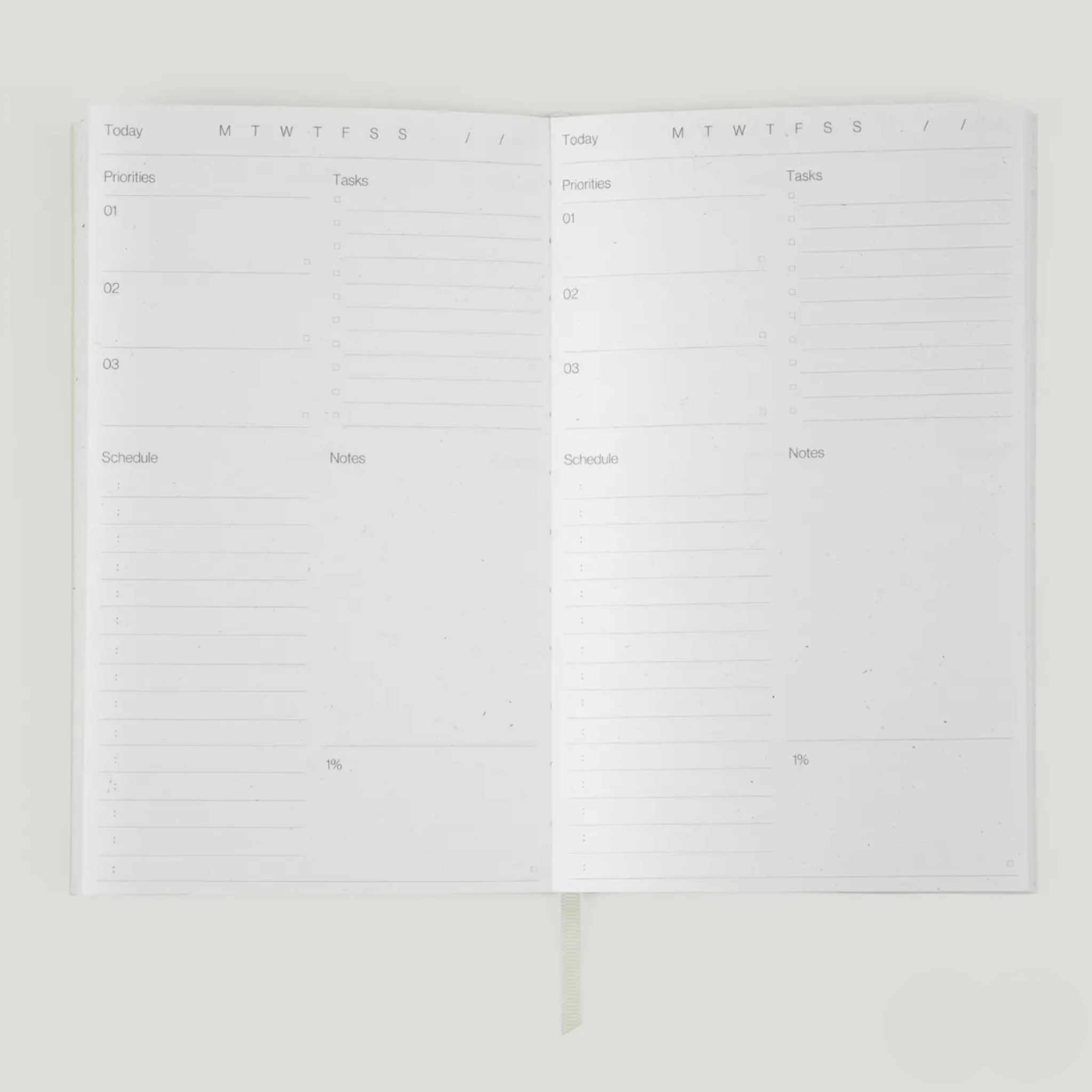 Open day planner spread showing priorities, tasks, schedule, and notes sections for effective daily planning.