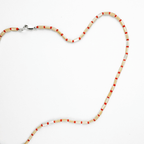 Karo necklace featuring mother of pearl and Japanese glass beads in warm sunset tones, perfect for everyday layering.