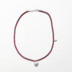 Anni Necklace featuring vibrant red coral, blue seed beads, and a freshwater pearl pendant on silk.