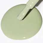 Sage green nail polish with a brush resting on a puddle of polish, showcasing the Forever Wear Chill Paint formula.