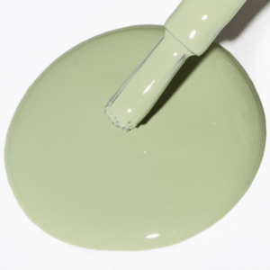 Sage green nail polish with a brush resting on a puddle of polish, showcasing the Forever Wear Chill Paint formula.