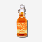 Bottle of Sideyard Kumquat Fruit-Infused Vinegar, 16 fl. oz., adding a zesty twist to cooking and cocktails.