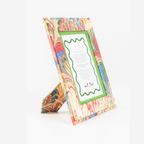 Hand-marbled picture frame showcasing vibrant colors, made from recycled cotton paper. A unique, sustainable keepsake.