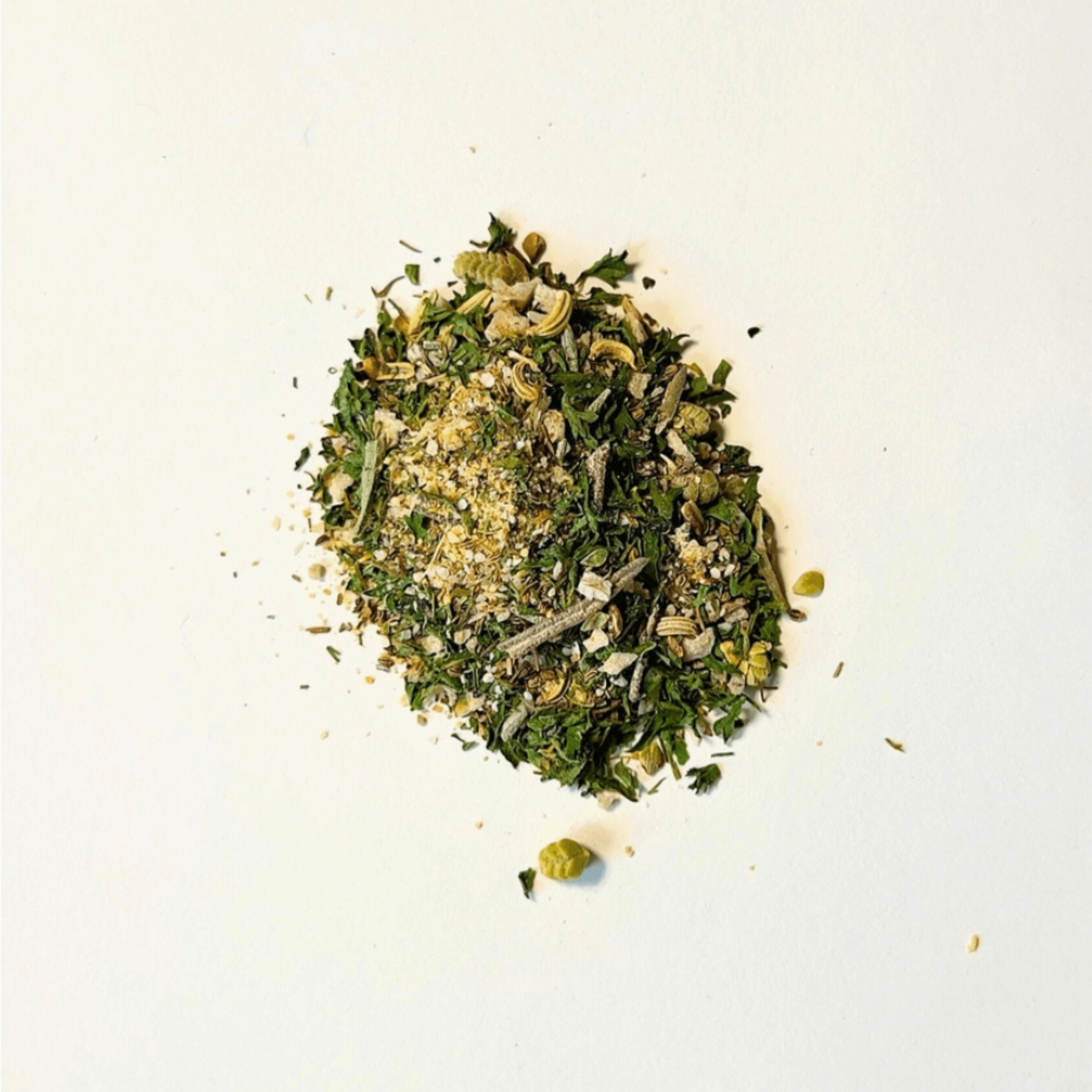 A vibrant pile of Herby Spice featuring a mix of herbs, seeds, and citrus, perfect for enhancing any dish.