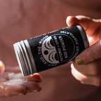 Hand holding Artemis at Dawn Bod Powder by Fat and the Moon, showcasing eco-friendly body care.