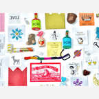 Colorful assortment of treasures from the Bluebird of Happiness Surprize Ball, including charms, toys, and whimsical surprises.