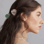 Model showcasing the AGATE HAIR CLAW in green, styled elegantly in the hair for a chic and effortless updo.