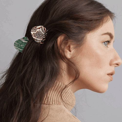 Model showcasing the AGATE HAIR CLAW in green, styled elegantly in the hair for a chic and effortless updo.